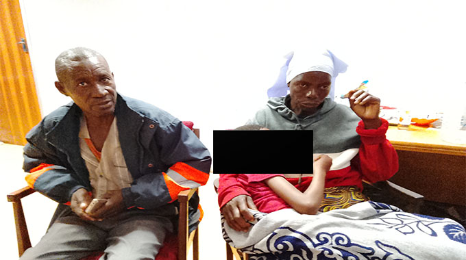 A distressed Gokwe family — the father and mother sitting beside their daughter wrapped in a blanket — appealing for help over her mysterious illness.