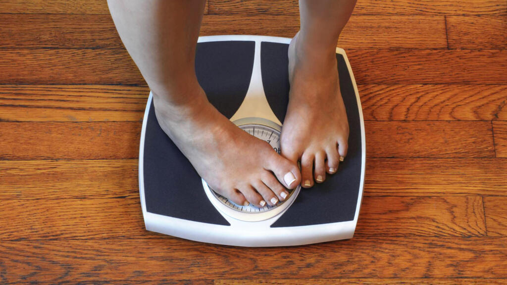 Child standing barefoot on a weighing scale
