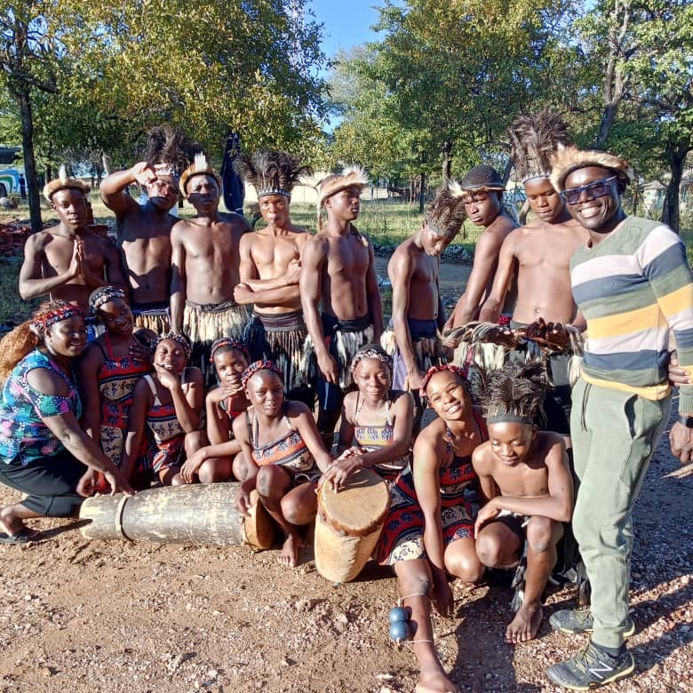 Chirozva High School dancers in traditional attire pose with drums and their coach at the 2026 Independence Day children’s party in Maphisa.
