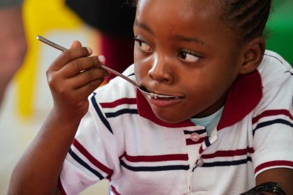Child eating food, illustrating how Zimbabwe food security data can help identify hungry households earlier.