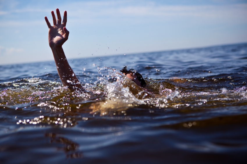 A person struggling in deep water, representing the Hartzell drowning and the urgent need for school safety in Zimbabwe.