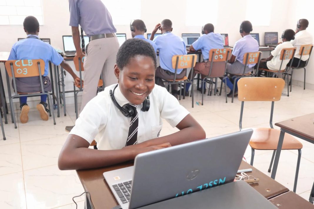 Zimbabwean learner using a laptop during a classroom lesson
