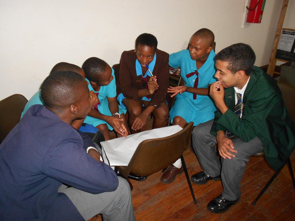 Secondary school students sharing ideas during a group discussion