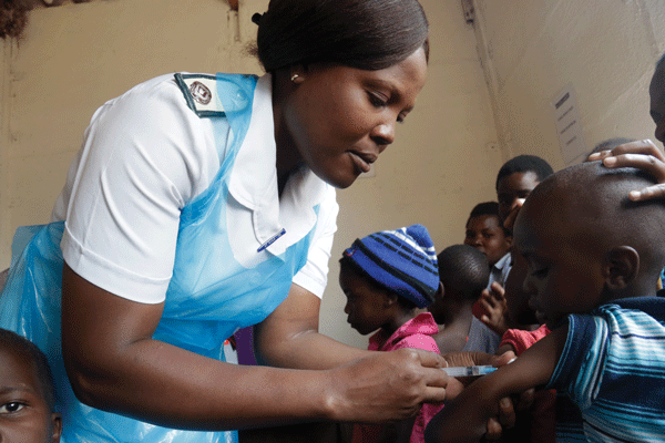 A nurse vaccinates a young child at a public health clinic
