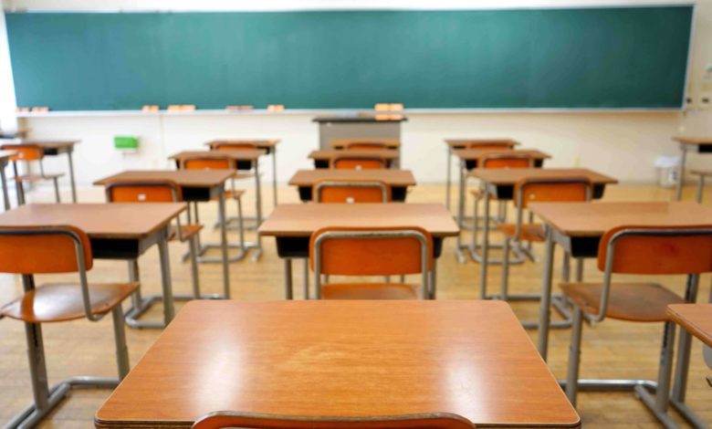 Empty classroom with text reading “BEAM arrears hit US$292.5 million.
